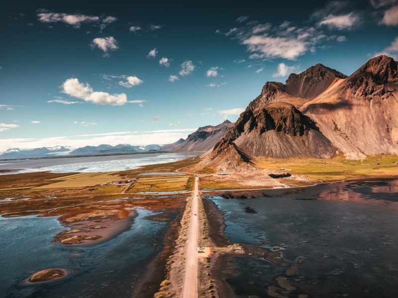 Landscape of Vestrahorn mountain with dirt road on black sand beach at Stokksnes, Iceland