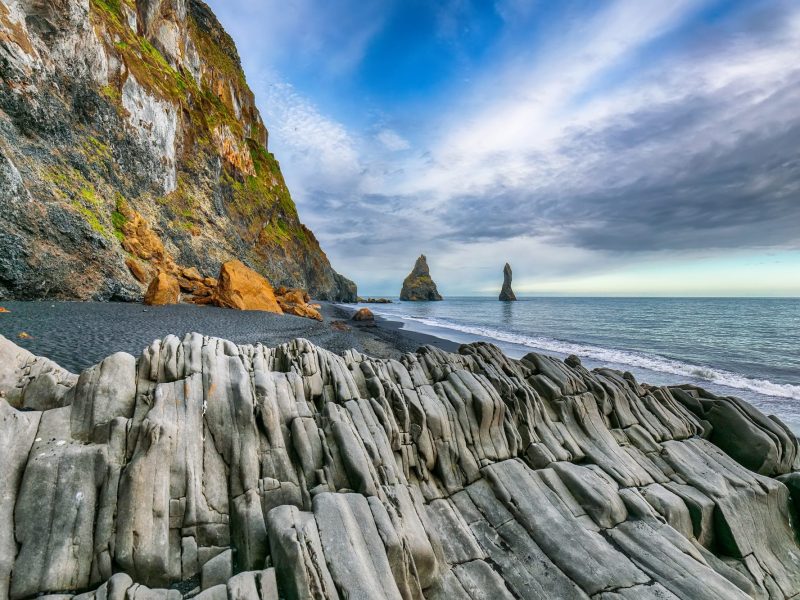 landscape with basalt rock formations Troll Toes on Black beach Reynisfjara near the village of Vik.