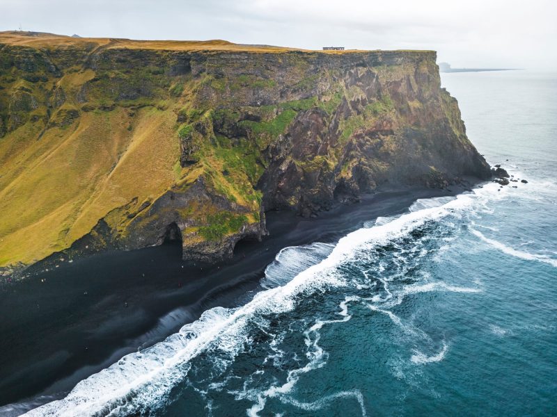 Steep cliff coastline of Reynisfjara black beach, Iceland
